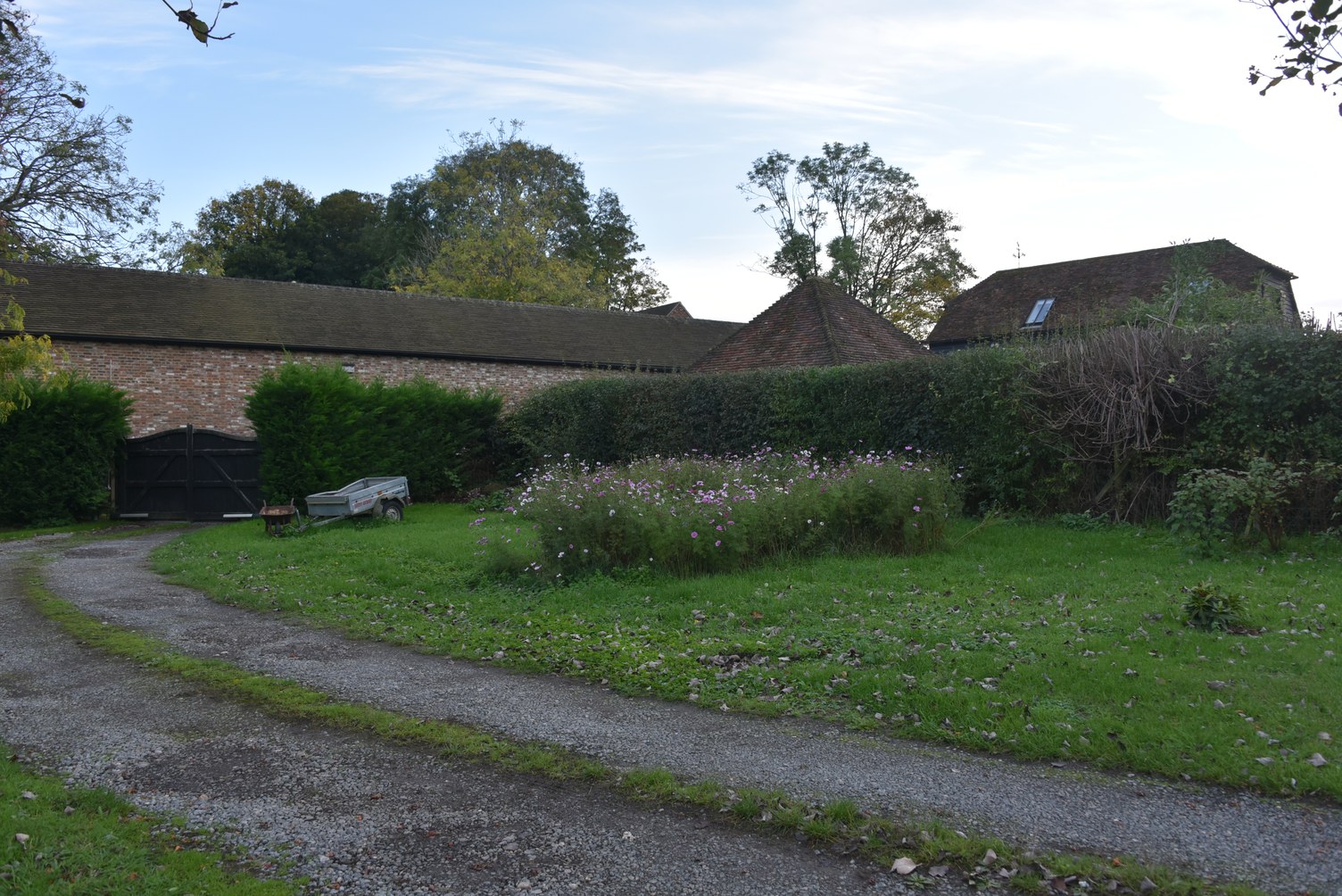 Photograph of the empty site beside the driveway